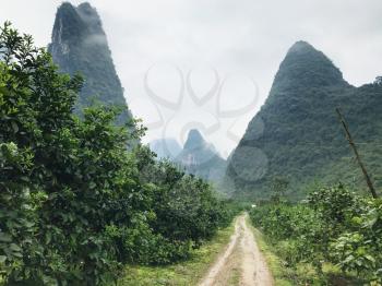 travel to China - country road between karst mountains in Yangshuo County in spring season