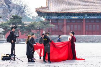 BEIJING, CHINA - MARCH 19, 2017: people in photosession on courtyard of Imperial Ancestral Temple (Taimiao, Working People's Cultural Palace) in Beijing Imperial city in spring