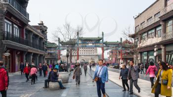 BEIJING, CHINA - MARCH 19, 2017: tourists near Qianmen gate on central pedestrian street Qianmen in Beijing city and view of Arrow Tower ( Jian Lou, Jianlou, Zhengyangmen Gate) in spring