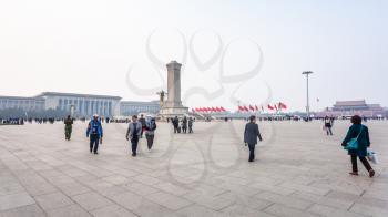 BEIJING, CHINA - MARCH 19, 2017: panorama of Tiananmen Square with people, Monument to the People's Heroes and Great hall of The people in spring. Tiananmen Square is central city square in Beijing