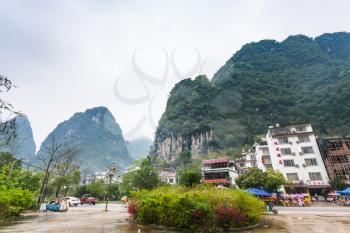 YANGSHUO, CHINA - MARCH 29, 2017: view of ecofarm village square under karst mountains in Yangshuo county. Town is resort destination for domestic and foreign tourists because of scenic karst peaks