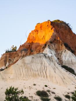 Travel to Algarve Portugal - slope of sandstone mountain on beach Praia Falesia near Albufeira city in evening