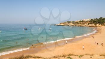 Travel to Algarve Portugal - people on urban beach Praia dos Alemaes in Albufeira city