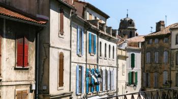 Travel to Provence, France - facades of old apartment houses in Arles city
