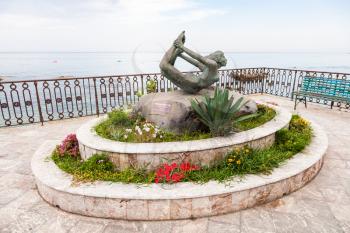 GIARDINI NAXOS, ITALY - JUNE 28, 2017: statue L' Arco (Arch) on waterfront in Giardini-Naxos town. Giardini Naxos is seaside resort on Ionian Sea coast since the 1970s