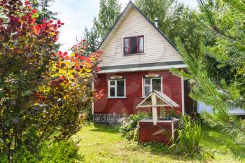 simple cottage and well on backyard in russian village in sunny summer day