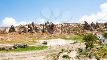 Travel to Turkey - rural landscape with ancient monastic settlement near Goreme town in Cappadocia in spring