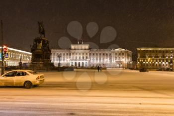 view of St Isaac's Square with Monument to Nicholas I and Mariinsky Palace in St Petersburg in snow night