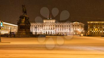 night panoramic view of St Isaac's Square with Monument to Nicholas I and Mariinsky Palace in St Petersburg in snowfall