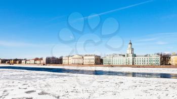 view of Universitetskaya Embankment with palaces on Vasilievsky Island in St Petersburg city from the Palace Bridge in sunny spring day