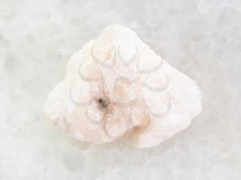macro shooting of natural mineral rock specimen - rough Barite stone on white marble background