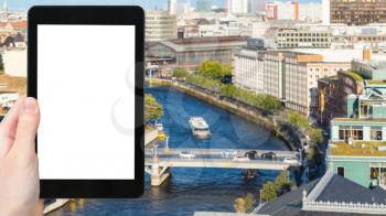 travel concept - tourist photographs Berlin city with Marschallbrucke bridge over Spree river in Mitte district in september on tablet with cut out screen for advertising logo