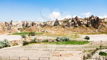 Travel to Turkey - rural scenery with ancient monastic settlement near Goreme town in Cappadocia in spring