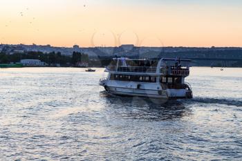 Travel to Turkey - excursion boat in Golden Horn bay in Istanbul city in spring evening