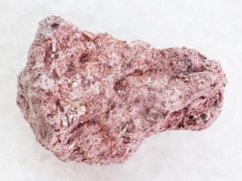 macro shooting of natural mineral rock specimen - rough Ash Tuff stone on white marble background