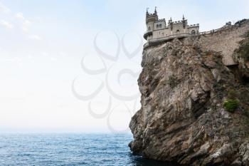 travel to Crimea - view of Swallow's Nest Castle on Aurora Cliff of Ai-Todor cape on Crimean South Coast of Black Sea on sunset
