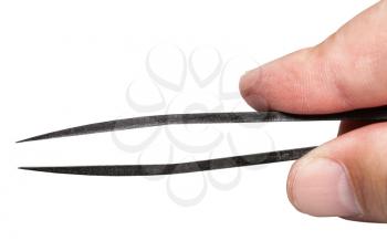 top view of male fingers holding black plastic tweezers with sharp tips isolated on white background