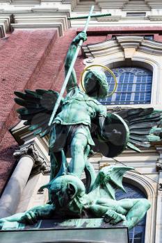 Travel to Germany - Victory of St Michael over the Devil, figure above the entrance of St Michael's church (Hauptkirche Sankt Michaelis) in Hamburg city