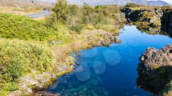 travel to Iceland - water in Silfra earth crack in rift valley of Thingvellir national park in september