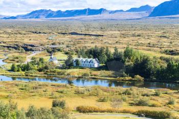 travel to Iceland - above view of valley with Thingvallakirkja church in Thingvellir national park in autumn