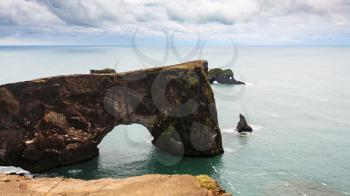 travel to Iceland - view of stone arch on Dyrholaey cape near Vik I Myrdal village on Atlantic South Coast in Katla Geopark in september