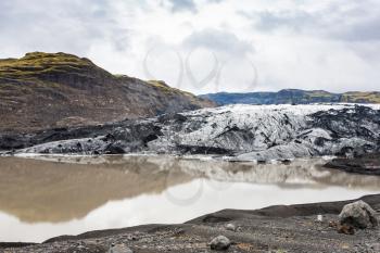 travel to Iceland - view of melting water and Solheimajokull glacier (South glacial tongue of Myrdalsjokull ice cap) in Katla Geopark on Icelandic Atlantic South Coast in september