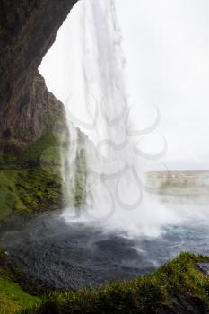 travel to Iceland - inside view of Seljalandsfoss waterfall of Seljalands River in Katla Geopark on Icelandic Atlantic South Coast in september