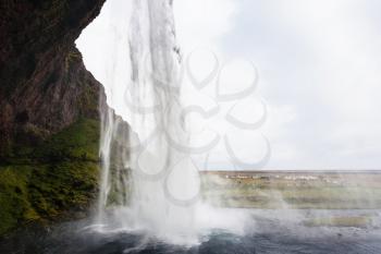 travel to Iceland - water stream of Seljalandsfoss waterfall of Seljalands River in Katla Geopark on Icelandic Atlantic South Coast in september