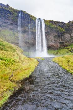 travel to Iceland - view of Seljalands River and Seljalandsfoss waterfall in Katla Geopark on Icelandic Atlantic South Coast in september