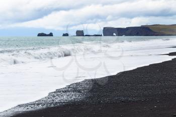travel to Iceland - view of Reynisfjara black Beach and Dyrholaey cape in Iceland, near Vik I Myrdal village on Atlantic South Coast in Katla Geopark in september
