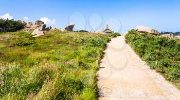 travel to France - footpath in natural park of Ploumanac'h site of Perros-Guirec commune on Pink Granite Coast of Cotes-d'Armor department of Brittany in sunny summer day