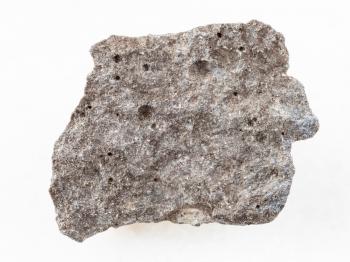 macro shooting of natural mineral rock specimen - piece of gray basalt stone on white marble background