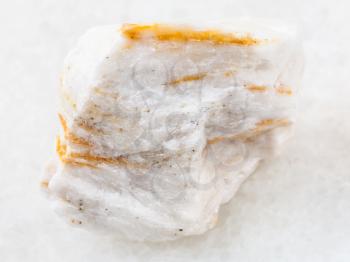 macro shooting of natural mineral rock specimen - rough Baryte ore on white marble background from Belorechenskoye mine, Adygea, Russia