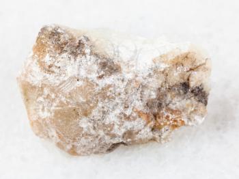 macro shooting of natural mineral rock specimen - piece of talc stone on white marble background from Irkutsk region