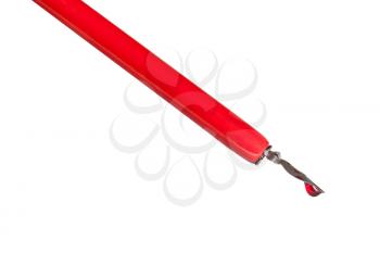 side view of ink drop in red nib pen close up isolated on white background