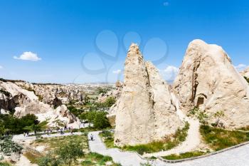 Travel to Turkey - people in ancient cave monastic settlement near Goreme town in Cappadocia in spring