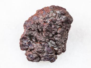 macro shooting of natural rock specimen - raw Goethite stone on white marble background from Tharsis, Spain