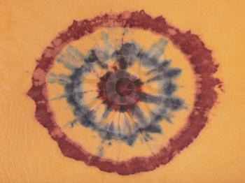 textile background - concentric circles hand-painted on brown silk in tie-dye batik technique