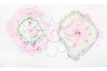 fragment of white silk scarf with abstract ornament in tie-dye batik technique isolated on white background