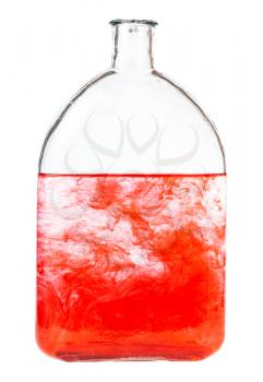 red dye dissolves in water in bottle isolated on white background