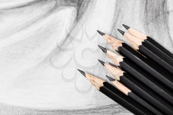 top view of set of black graphite pencils on hand-drawn academic drawing close up