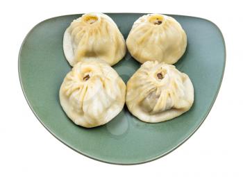 four steamed Buuz (Mongolian dumpling filled with minced meat) on green plate isolated on white background
