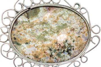 surface of natural Moss Agate in vintage pendant close up isolated on white background