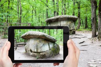 travel concept - tourist photographs of the prehistoric large Shapsugsky Dolmen in Abinsk Foothills in Shapsugskaya anomalous zone of Caucasus Mountains in Kuban region of Russia on smartphone