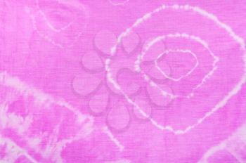 detail of abstract ornament of pink scarf colored in tie-dye batik technique