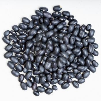 top view of pile of black mexico beans close up on gray ceramic plate