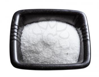 crystalline monosodium glutamate flavoring in black bowl isolated on white background