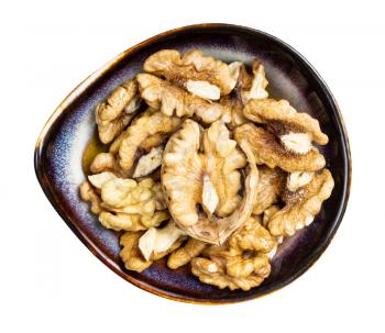 top view of shelled walnuts in ceramic bowl isolated on white background