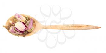 top view of old dried rosebuds in wood spoon isolated on white background