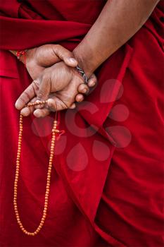 Tibetan Buddhism - prayer beads in Buddhist monk hands. Ladakh, India